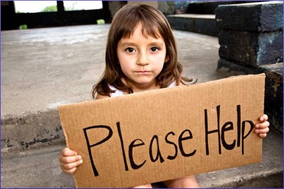 Child holding poverty sign