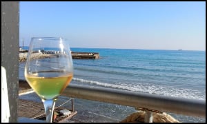 Glass of wine at restaurant looking over sea