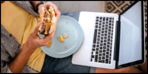 eating hamburger over MacBook