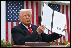 Donald Trump holds up Executive Order 
